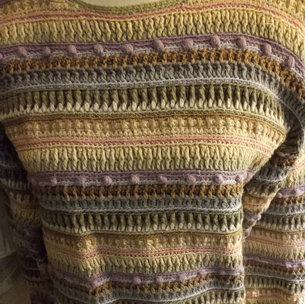 Used,not new, never worn hand knitted multi colored round neck sweater size s.